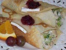 crepes filled with chicken salad and topped with melted brie