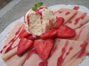 strawberry crepe recipe drizzled with our homemade strawberry sauce