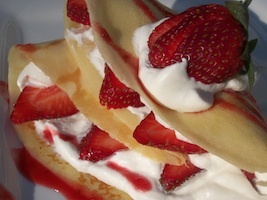 strawberry crepes with whipped cream and strawberry sauce