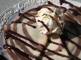 chocolate and vanilla swirled crepes topped with ice cream