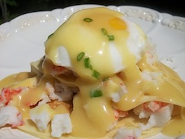 crab eggs benedict with hollandaise sauce over crepes