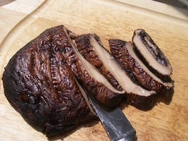 grilled portobello mushrooms on cutting board