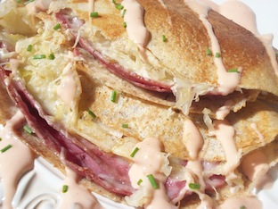 rye crepes filled with corned beef, swiss cheese and sauerkraut