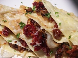 roasted garlic crepes filled with sundried tomatoes and onions